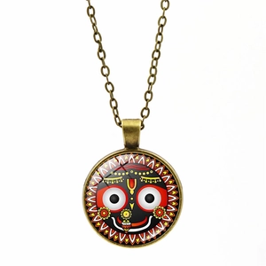 Macro shot of Jagannath glass dome pendant with antique bronze alloy chain necklace