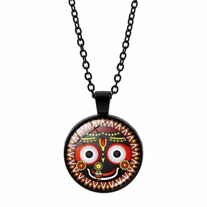 Detailed macro view of the Lord Jagannath glass pendant on a black alloy chain necklace