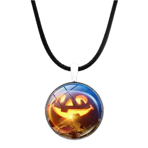 Close-up of Halloween pendant with glowing pumpkin glass cabochon and black leather cord