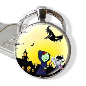 Detail of Halloween keychain with glass cabochon featuring witch and bat illustrations