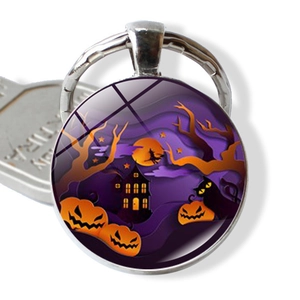 Detail of Halloween key ring with glass gemstone featuring pumpkin and witch motifs