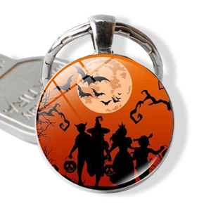 Halloween keychain with silver metal frame and round glass moon silhouette design