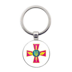 Detail of silver alloy keychain featuring circular Ukrainian trident and cross emblem