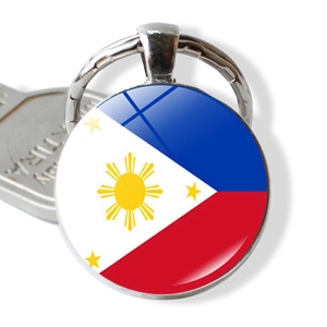 Detailed close-up of a silver keychain featuring the Philippines flag under glass dome