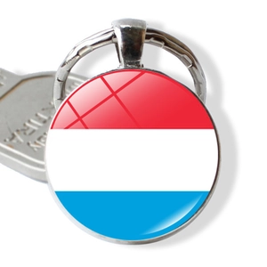 Detail of metal keychain with Luxembourg flag glass dome pendant and a polished key ring