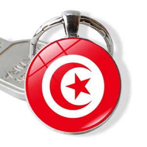 Detailed close-up of a circular glass dome keychain featuring the red and white Tunisia flag