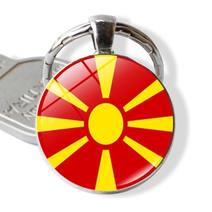 Macro view of a North Macedonia flag keychain with silver metal frame and glass dome