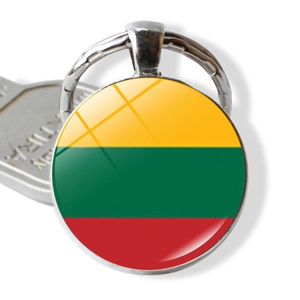 Macro shot of silver metal keychain with Lithuania flag design under glass dome