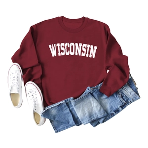 Flat lay of a burgundy Wisconsin crewneck sweatshirt with denim shorts and white shoes