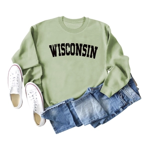 Flat lay of a sage green Wisconsin sweatshirt paired with blue jeans and white canvas shoes