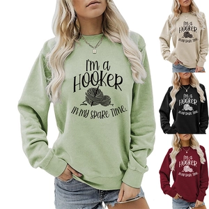 Close-up of ribbed cuffs and crochet pattern print on long sleeve sweatshirt