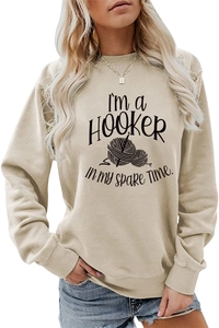 Detail of creative knitting graphic and text on a beige long sleeve crewneck sweatshirt
