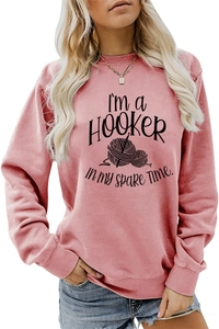 Detail view of pink sweatshirt featuring I'M a Hooker crochet graphic and ribbed cuffs