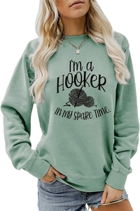 Detail of green crewneck sweatshirt featuring I'M A HOOKER crochet text and yarn pattern