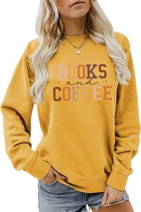 Close-up of Books and Coffee typography print on yellow long-sleeved sweatshirt fabric