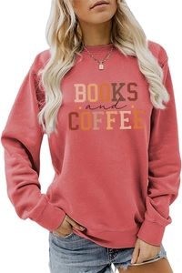 Detail showing 'BOOKS and COFFEE' print on a coral pink crewneck long sleeve sweatshirt