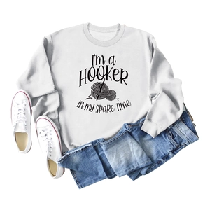 Detail of ribbed neckline and creative crochet graphic on light grey sweatshirt