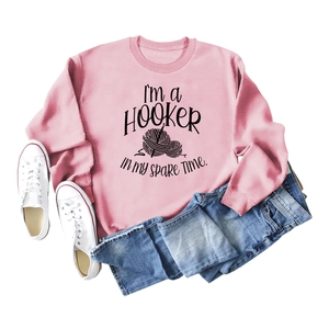 Pink crewneck sweatshirt with I'm a Hooker slogan and yarn ball graphic on white background