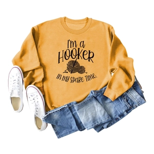 Flat lay of ginger crewneck sweatshirt with 'I'm a HOOKER' crochet theme graphic
