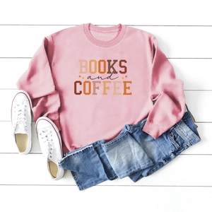 Flat lay of pink Books and Coffee sweatshirt with denim shorts on white wood background
