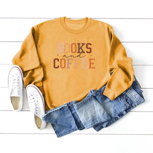 Flat lay of ginger yellow crewneck sweatshirt featuring Books and Coffee graphic print