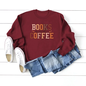 Flat lay of burgundy Books and Coffee sweatshirt with blue jeans and white sneakers