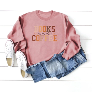 Flat lay of pink Books and Coffee sweatshirt with blue jeans and white sneakers