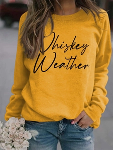 Detail of Whiskey Weather slogan print on mustard yellow long sleeve sweatshirt