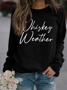 Close-up of Whiskey Weather letter print on black crewneck sweatshirt with rose