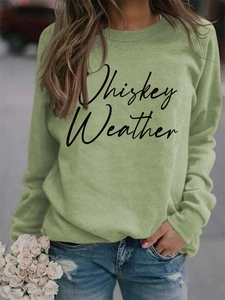 Detail of sage green sweatshirt featuring Whiskey Weather cursive print and crew neck