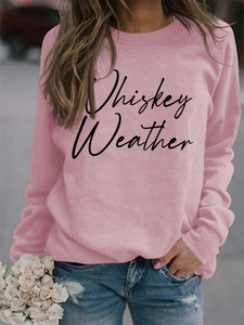 Close-up of pink long-sleeved sweatshirt with Whiskey Weather lettering print