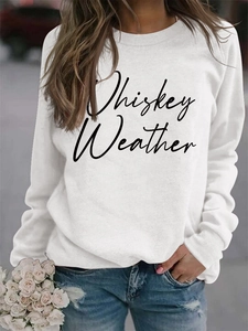 Close-up of Whiskey Weather script lettering on a soft white long-sleeve sweatshirt