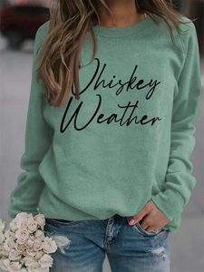 Close-up of Whiskey Weather letter print on green long sleeve round neck sweatshirt