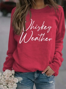 Detail of Whiskey Weather lettering on dark red long sleeve sweatshirt for women