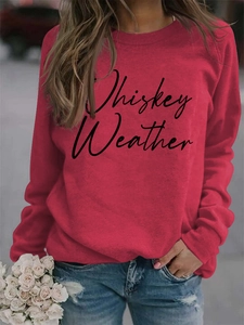Close-up of Whiskey Weather letter print on red long sleeve crewneck sweatshirt