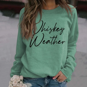 Detail of Whiskey Weather cursive print on green crewneck long sleeve sweatshirt