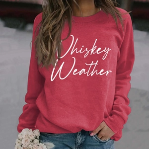 Close-up of Whiskey Weather letter print on red long sleeve crewneck sweatshirt