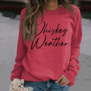 Detail of red crewneck sweatshirt featuring black Whiskey Weather cursive text print