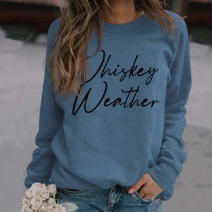 Detail of Whiskey Weather script print on blue long-sleeve sweatshirt with ribbed cuffs