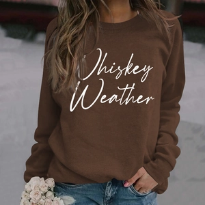 Close-up of brown crew neck sweatshirt featuring white Whiskey Weather script lettering