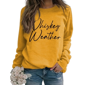 Detail of Whiskey Weather cursive letter print on yellow long sleeve crewneck sweatshirt