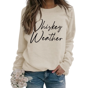 Close-up of Whiskey Weather script print on beige crewneck sweatshirt for women