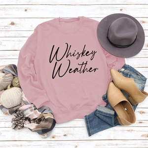 Detailed flat lay of pink long sleeve sweatshirt with black Whiskey Weather text print