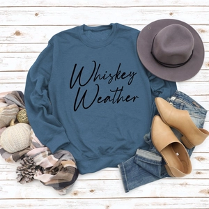 Flat lay of Whiskey Weather navy sweatshirt styled with autumn boots and accessories