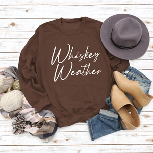 Flat lay of brown Whiskey Weather sweatshirt styled with fall fashion accessories