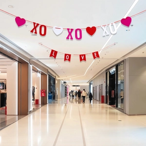 Detail of red and pink LOVE and XO felt banners for Valentine's Day party decoration
