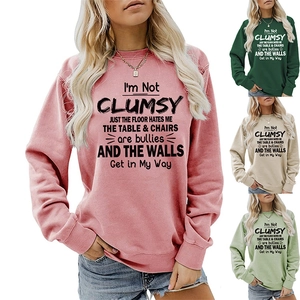 Close-up of crewneck sweatshirts in pink, dark green, beige and sage green colors