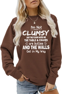 Detail showing the white humorous quote print on a brown crewneck long sleeve sweatshirt