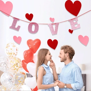Pink glitter LOVE banner with red heart hanging decorations for wedding room setting