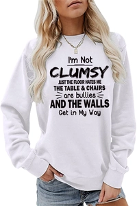 Detail of vintage black lettering print on a white crewneck long sleeve sweatshirt